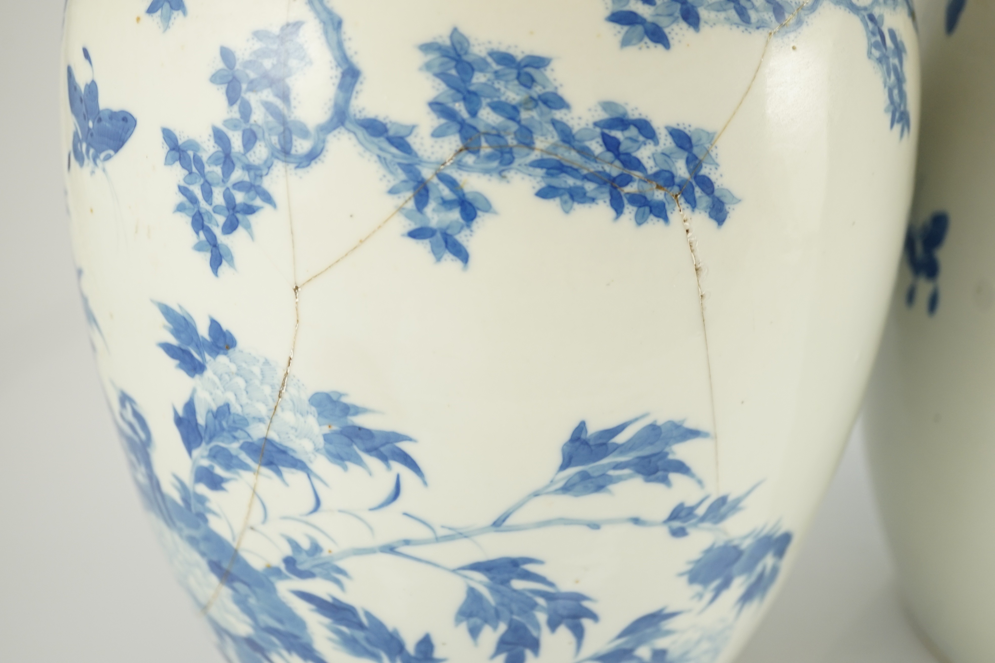 A pair of large Chinese blue and white ovoid jars and associated covers, 19th century, 34.5cm high, damage and repairs